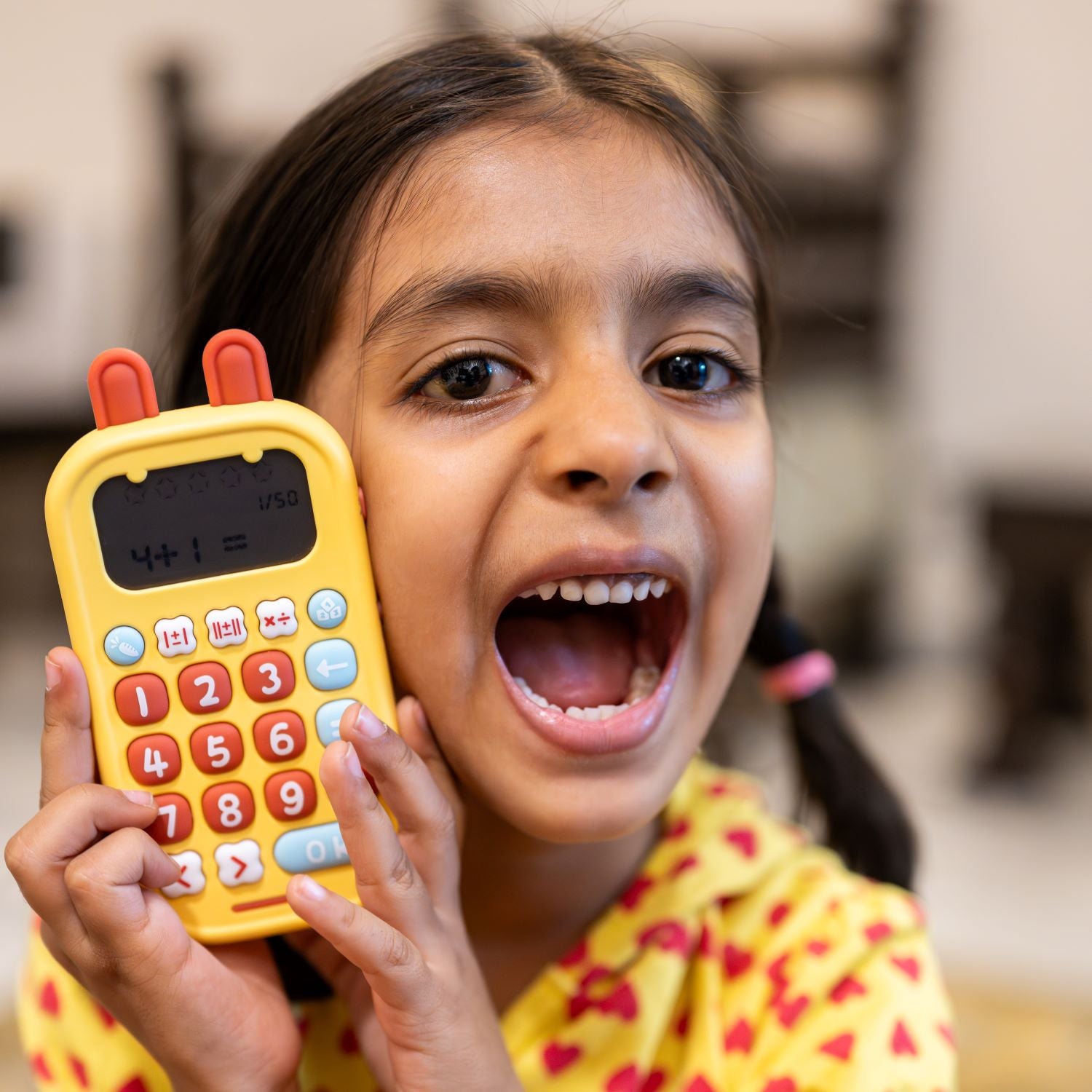 Child holding Math Champion with a joyful expression.